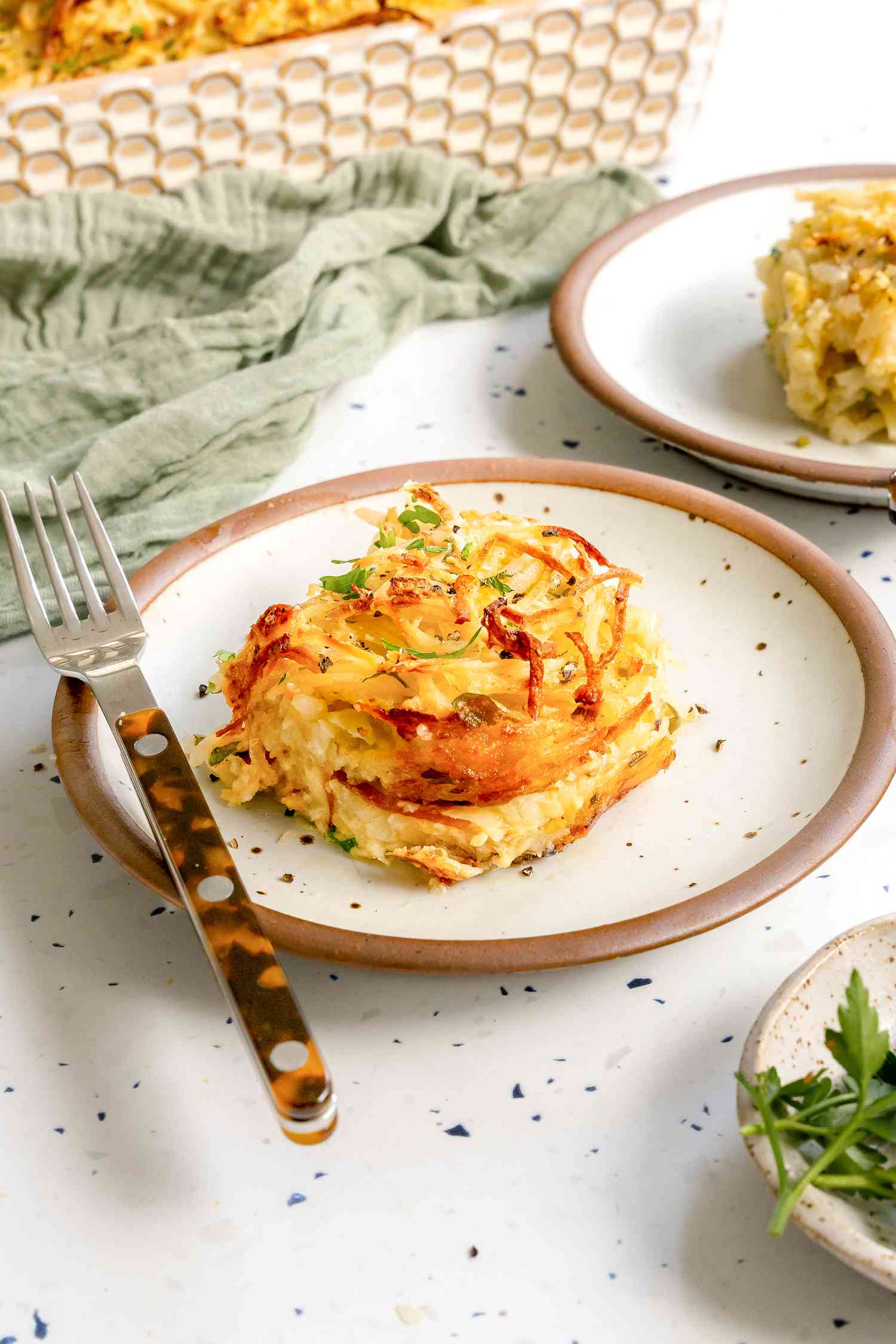 Serving of Potato Kugel on a Plate with a Fork